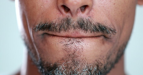 Obraz premium Man with mouth zipped, lips pressed close-up, feeling anxiety