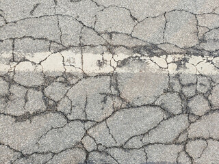 Texture cracks in the asphalt of the road