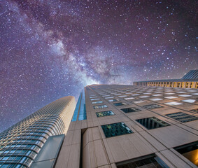 Starry night over modern city buildings, business and corporate concept,