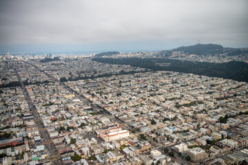 Aerial view of San Francisco outskirts from helicopter, homes and streets.