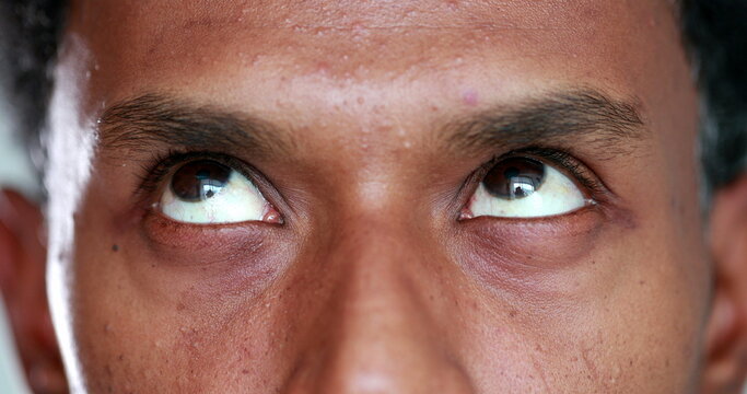 Extreme close-up of african american man eyes looking up , down and sideways