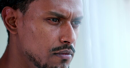 Concentrated African american thinking about solution, pensive black person portrait face