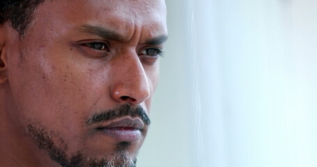 Obraz premium Concentrated African american thinking about solution, pensive black person portrait face