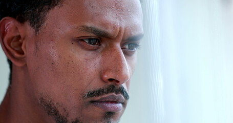 Concentrated African american thinking about solution, pensive black person portrait face