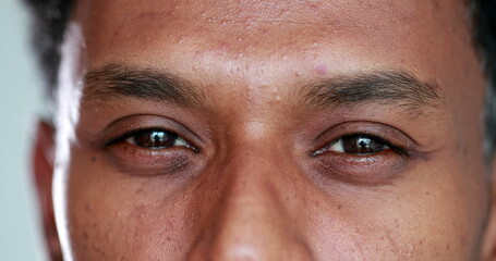 Close-up face african descent closing and opening eyes, smiling reaction