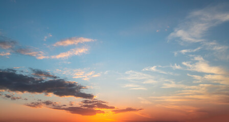 Naklejka na ściany i meble Fantastic bright clouds in the sunset sky. Sky background.