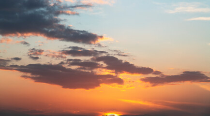 Fantastic bright clouds in the sunset sky. 
Sky background.