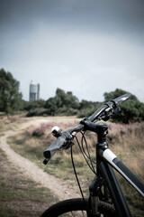 Bike on path heading towards tower in distance, Rushmere, Suffolk, UK