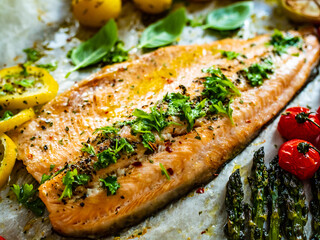 One sheet pan roast trout fillet with potatoes, asparagus and vegetables