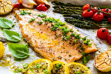 One sheet pan roast trout fillet with potatoes, asparagus and vegetables