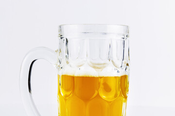 Glass beer mug with light beer on white background