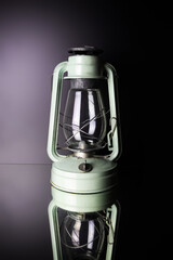 Kerosene lamp extinguished on black mirror surface