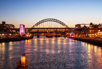 Colourful reflections on the river tyne at sunset, with the tyne bridges in the background.