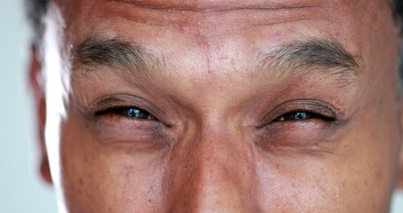 Obraz premium African man eyes squinting. Close-up black guy closing eyes squint