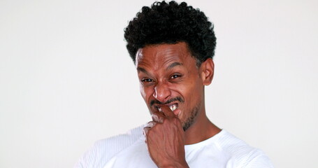 African man disgust face reaction. Black guy feeling dislike