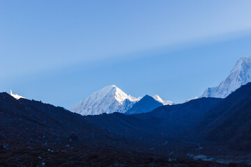 Obraz na płótnie Canvas Snowy mountain peaks at dawn in the Himalayas Manaslu region