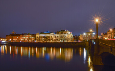 Fototapeta na wymiar Night city landscape, reflection of street lights in the river, bridge