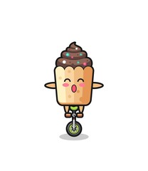 The cute cupcake character is riding a circus bike