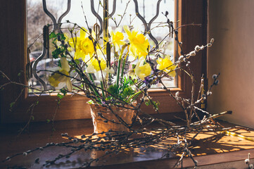Easter spring bouquet of yellow daffodils in basket and willow © Cavan