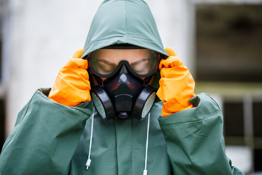 A Dosimetrist Scientist In Protective Clothing And A Gas Mask Checks The Level Of Radioactive Radiation In The Danger Zone. Environmental Pollution, Disaster