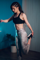 Young woman doing fitness exercises while training at home