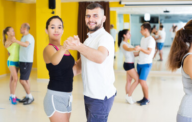 Group of happy young people have fun while dancing tango