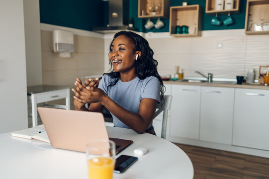 Young african american woman working from home and using a laptop
