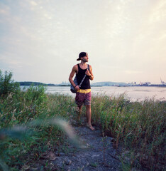 Young man dressed for summer at waterfront