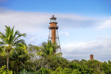 Fototapeta na wymiar Scenic view of lighthouse on Sanibel Island with blue sky and puffy white clouds before Hurricane Ian