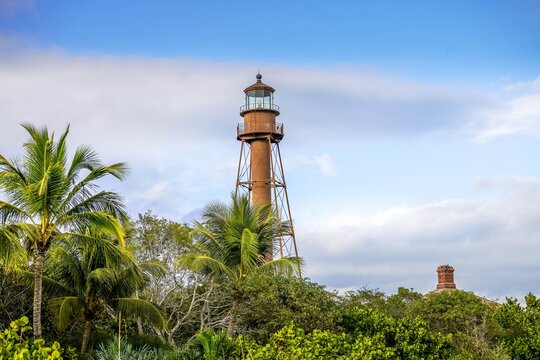 Scenic view of lighthouse on Sanibel Island with blue sky and puffy white clouds before Hurricane Ian