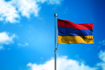 Flag of Armenia on the wind against blue sky