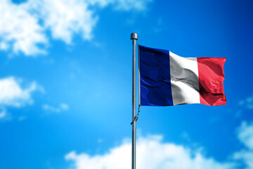 Flag of France on the wind against blue sky