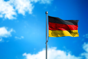 Flag of Germany on the wind against blue sky