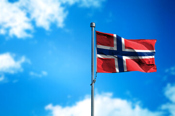 Flag of Norway on the wind against blue sky