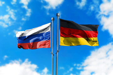 Flags of Russia and Germany on the wind against blue sky