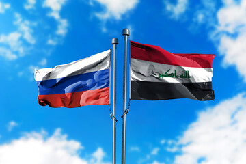 Flags of Russia and Iraq on the wind against blue sky