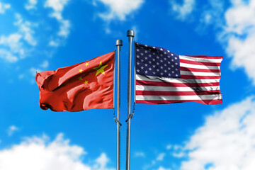 Flags of America and China on the wind against blue sky