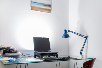 home workstation with office and computer with blue lamp
