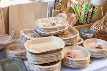 Dishes made from dry pressed palm leaves on market in Thailand. Concept of reuse of waste....