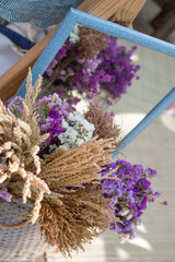 Small bouquets from dried flowers in basket on street eco market.