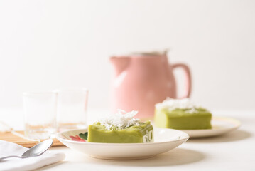 Pandanus pudding with coconut topping on white background, Traditional sweets that are cultural heritage of Asia.