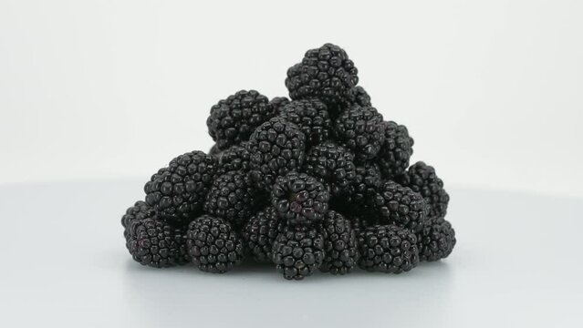 Bunch of Blackberries rotating on the turntable. Isolated on White Background. Closeup