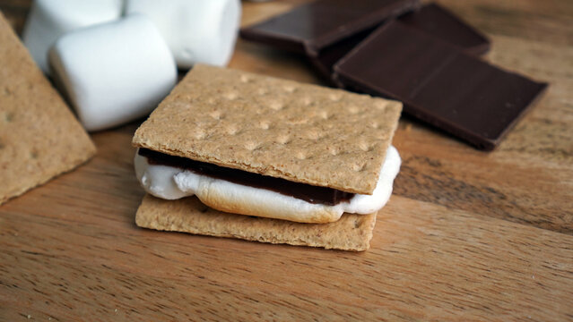 Making s'mores with graham crackers, chocolate, and marshmallows