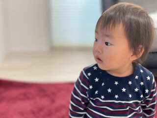 A one-year-old boy with a serious expression