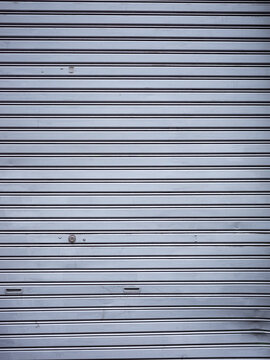 line patter of the closed metallic shutter door on the street of shibuya