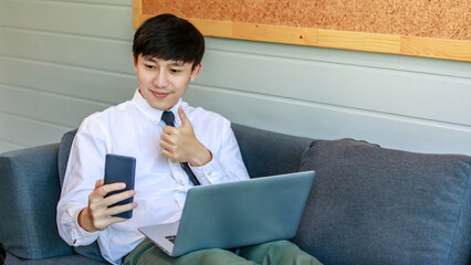 Modern businessmen lie down on lobby couch for casual relaxation by stretching legs and working...