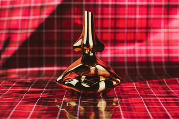 Bottle of perfume in a red background