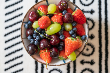 Strawberries, blueberries, cherries, grapes in a bowl