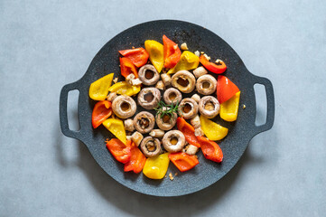 Mushrooms and bell peppers on a baking sheet