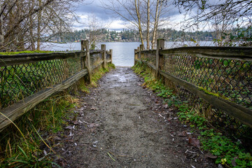 Access to Lake Washington from a gravel walking trail in Luther Burbank Park on Mercer Island, WA, winter recreation on a cold sunny day
